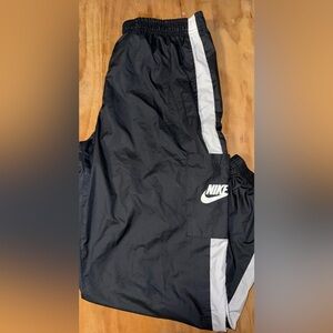 Nike woman track pants black and white stripes.
